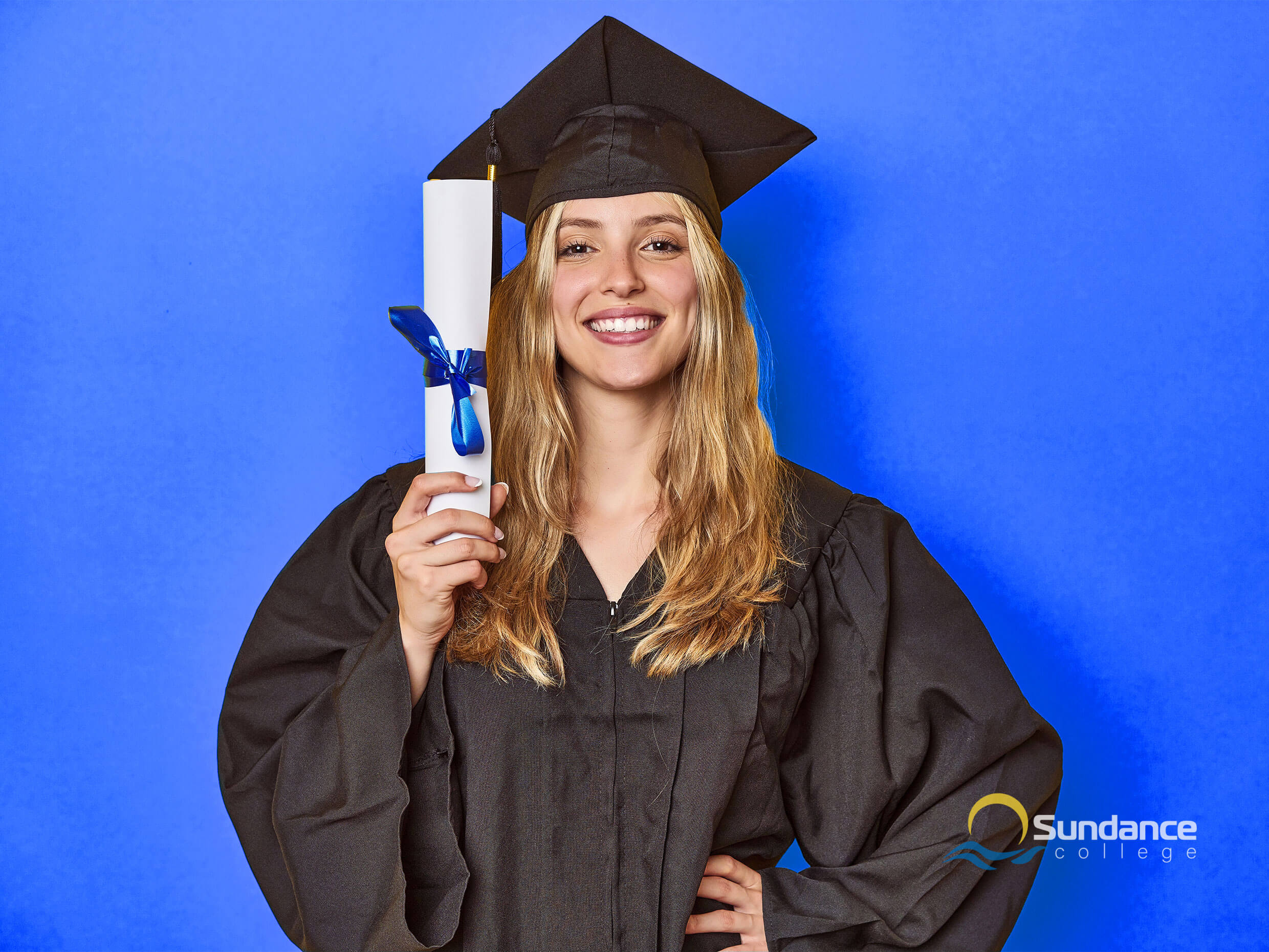 a medium portrait of a young woman in graduation cap and gown smiling and holding a diploma, satisfied with her career prospects after finishing a payroll administration diploma